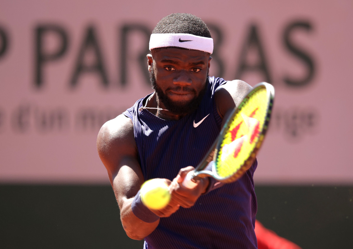 Frances Tiafo plays a backhand in a mens singles match.