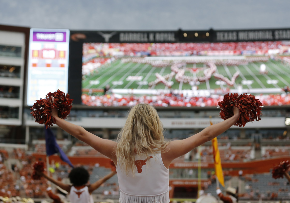 AUSTIN, TX - SEPTEMBER 03: Texas Longhorns cheerleader raises her pom pom while the Texas band performs prior to the game against the University of Louisiana Monroe Warhawks on September 03, 2022, at Darrell K Royal - Texas Memorial Stadium in Austin, TX. (Photo by Adam Davis/Icon Sportswire via Getty Images)