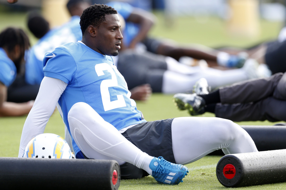 J.C. Jackson stretches on the ground during Chargers training camp.