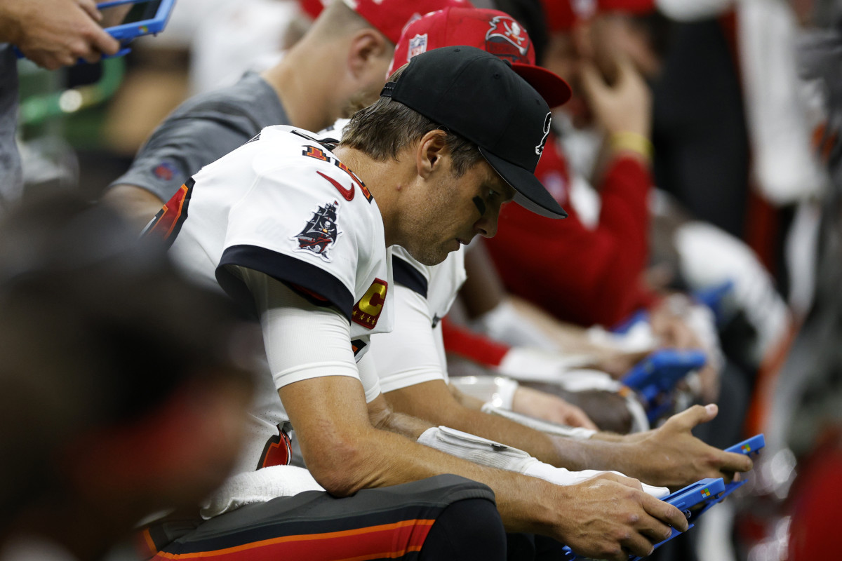 Tom Brady looks at a tablet during his team's game on Sunday afternoon.