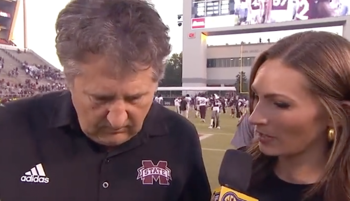 Mike Leach and Alyssa Lang on the field.