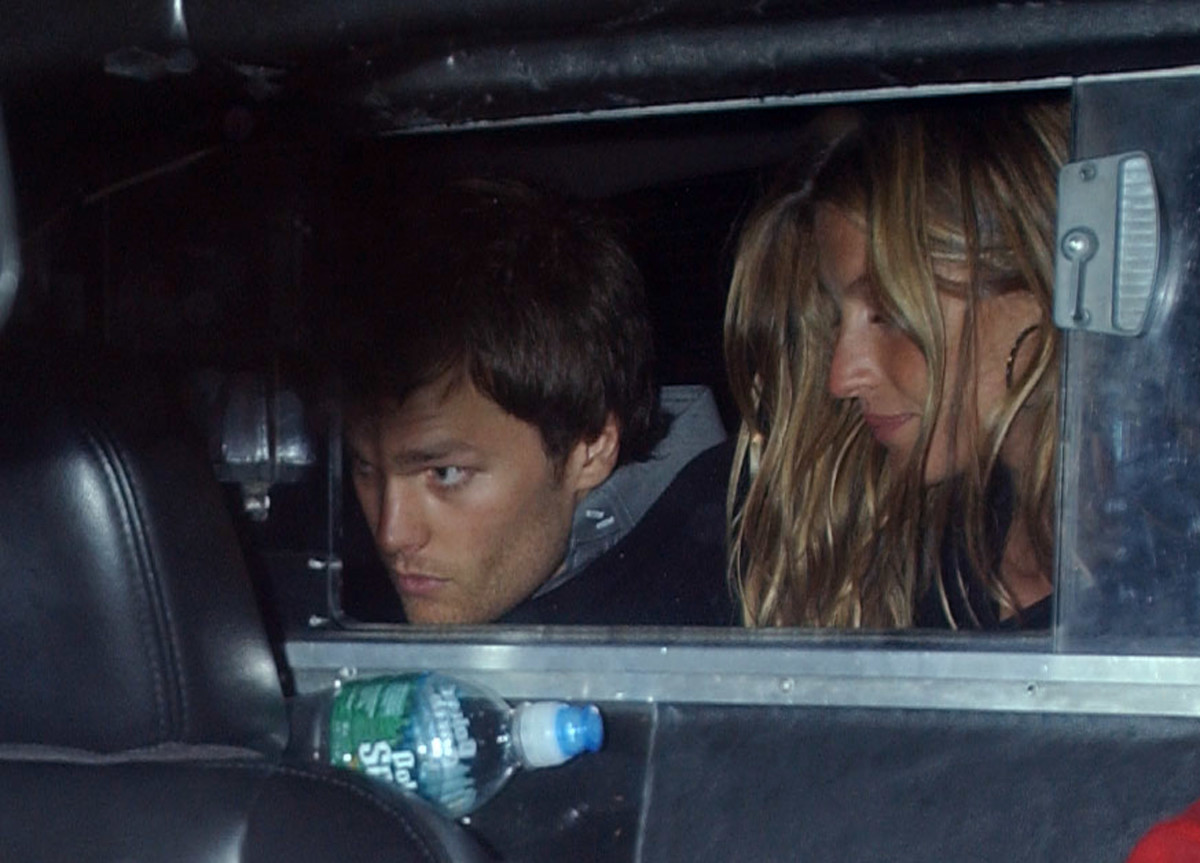 Tom Brady and Gisele Bundchen in the back of a car.