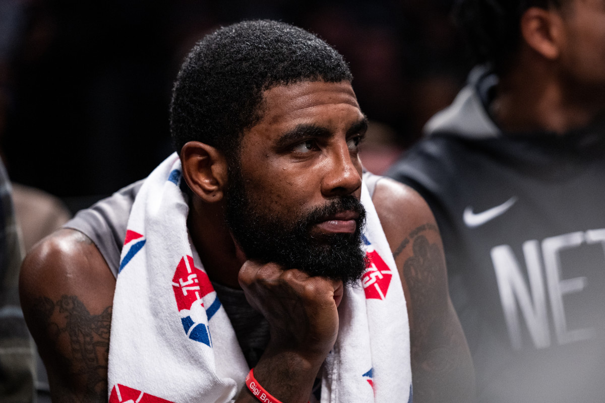 Kyrie Irving looks on while on the Nets' bench.