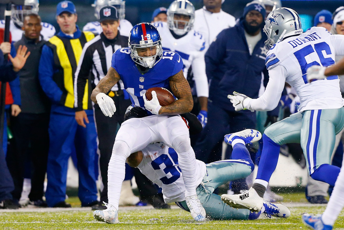 Odell Beckham is tackled by a Dallas Cowboys defender while playing for the Giants.