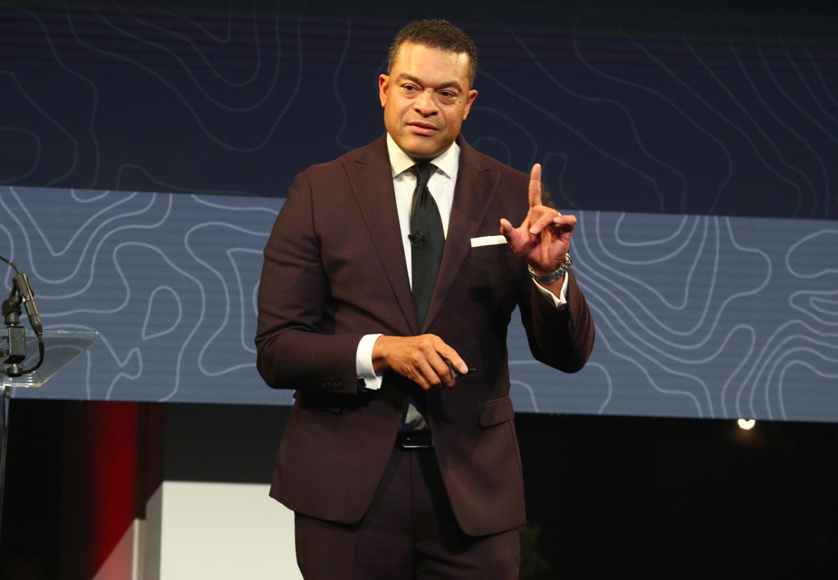ESPN's Michael Eaves speaks on stage at an event.