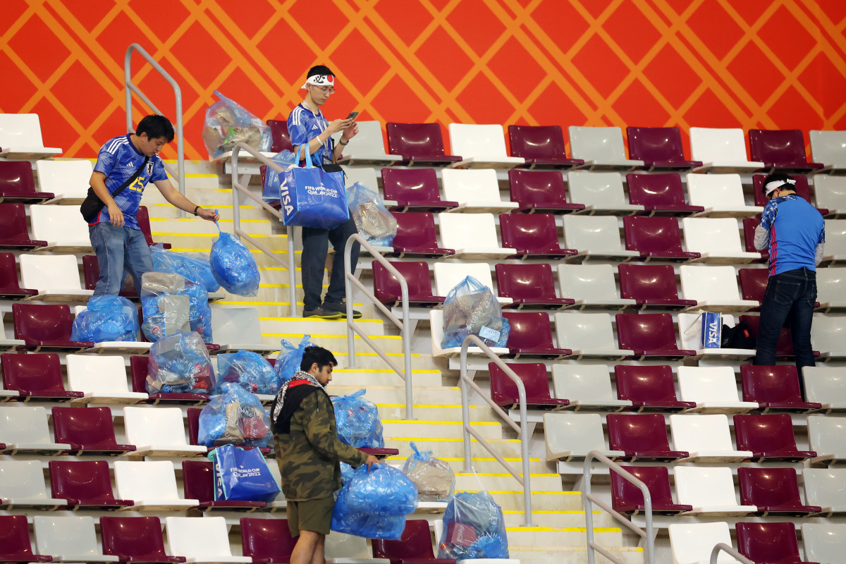 Japan supporters cleaning Khalifa International Stadium.