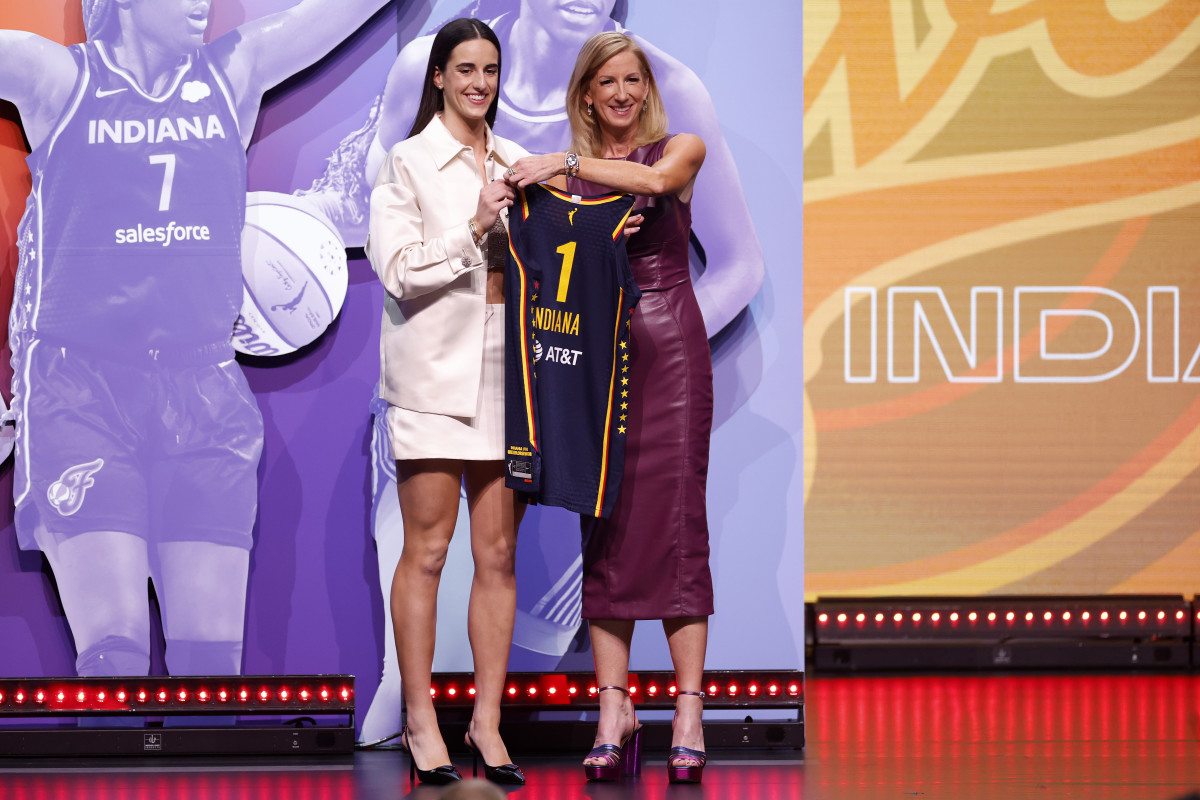 Caitlin Clark on stage after being the No. 1 overall pick in the WNBA Draft.