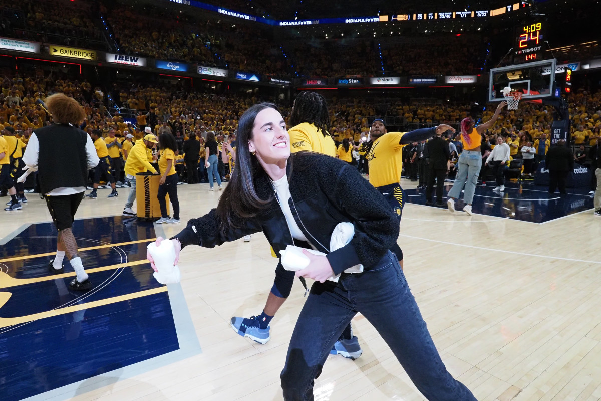 INDIANAPOLIS, IN - APRIL 26:  Caitlin Clark #22 of the Indiana Fever throws out t-shirts during halftime of the game between the Milwaukee Bucks  and the Indiana Pacers during Round 1 Game 3 of the 2024 NBA Playoffs on April 26, 2024 at Gainbridge Fieldhouse in Indianapolis, Indiana. NOTE TO USER: User expressly acknowledges and agrees that, by downloading and or using this Photograph, user is consenting to the terms and conditions of the Getty Images License Agreement. Mandatory Copyright Notice: Copyright 2024 NBAE (Photo by Ron Hoskins/NBAE via Getty Images)