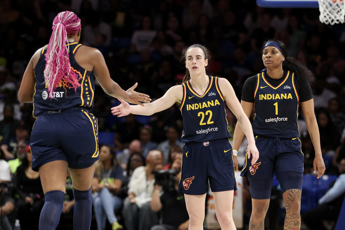 ARLINGTON, TEXAS - MAY 03: Caitlin Clark #22 of the Indiana Fever high-fives Aliyah Boston #7 after a basket against the Dallas Wings during the second quarter in the preseason game at College Park Center on May 03, 2024 in Arlington, Texas. (Photo by Gregory Shamus/Getty Images)