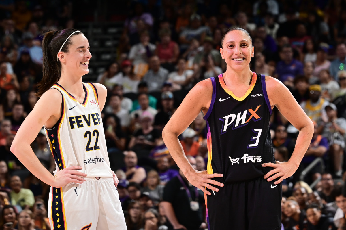 Diana Taurasi and Caitlin Clark smile and interact during a game.