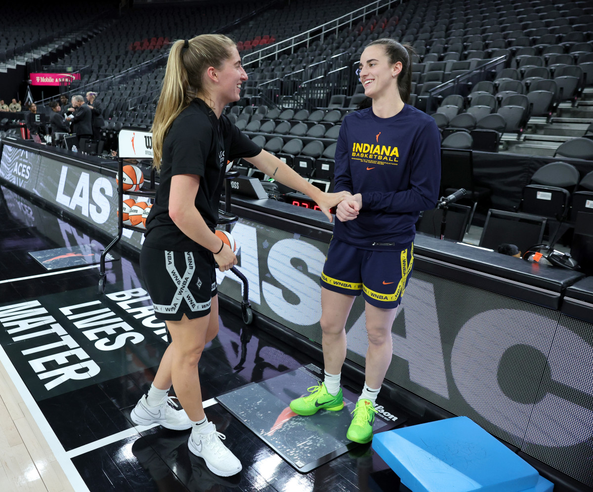 LAS VEGAS, NEVADA - JULY 02: Former Iowa Hawkeyes teammates Kate Martin (L) #20 of the Las Vegas Aces and Caitlin Clark #22 of the Indiana Fever talk on the court during warmups before their game at T-Mobile Arena on July 02, 2024 in Las Vegas, Nevada. NOTE TO USER: User expressly acknowledges and agrees that, by downloading and or using this photograph, User is consenting to the terms and conditions of the Getty Images License Agreement. (Photo by Ethan Miller/Getty Images)