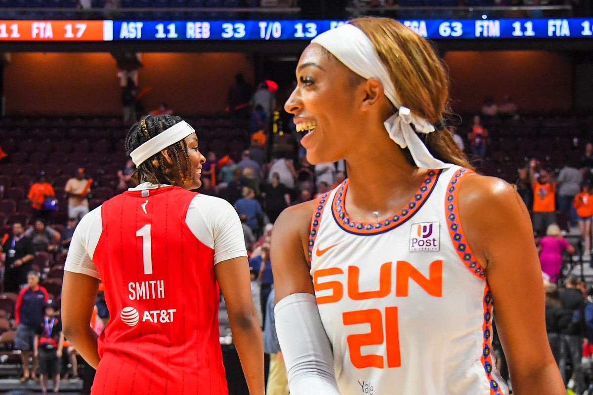 DiJonai Carrington and NaLyssa Smith on the court following a WNBA game.