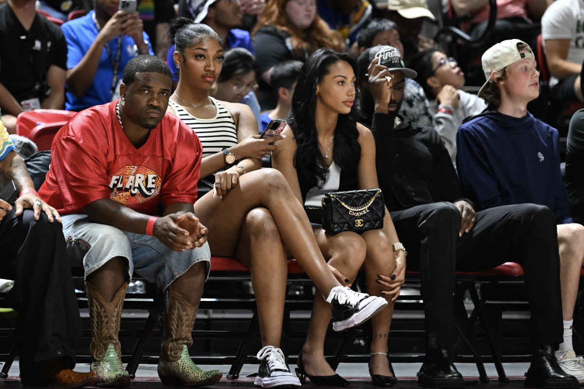 Angel Reese courtside with Kysre Gondrezick and Jaylen Brown.