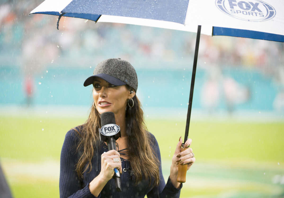 MIAMI GARDENS, FL - DECEMBER 11: FOX Sports field reporter Holly Sonders holds a microphone and umbrella in the rain on the field after the NFL football game between the Arizona Cardinals and the Miami Dolphins on December 11, 2016, at the Hard Rock Stadium in Miami Gardens, FL. (Photo by Doug Murray/Icon Sportswire via Getty Images)