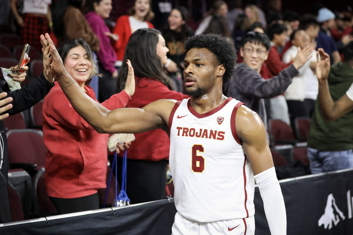 LOS ANGELES, CALIFORNIA - JANUARY 03: Bronny James #6 of the USC Trojans high-fives fans after defeating the California Golden Bears at Galen Center on January 03, 2024 in Los Angeles, California. (Photo by Meg Oliphant/Getty Images)