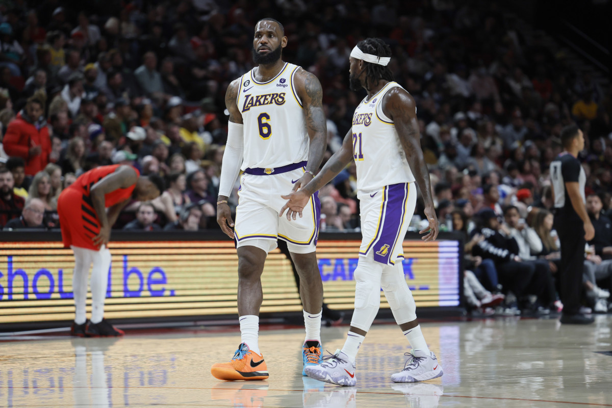 Los Angeles Lakers small forward LeBron James (6) and point guard Patrick Beverley (21) talk during the second half against the Portland Trail Blazers at Moda Center.