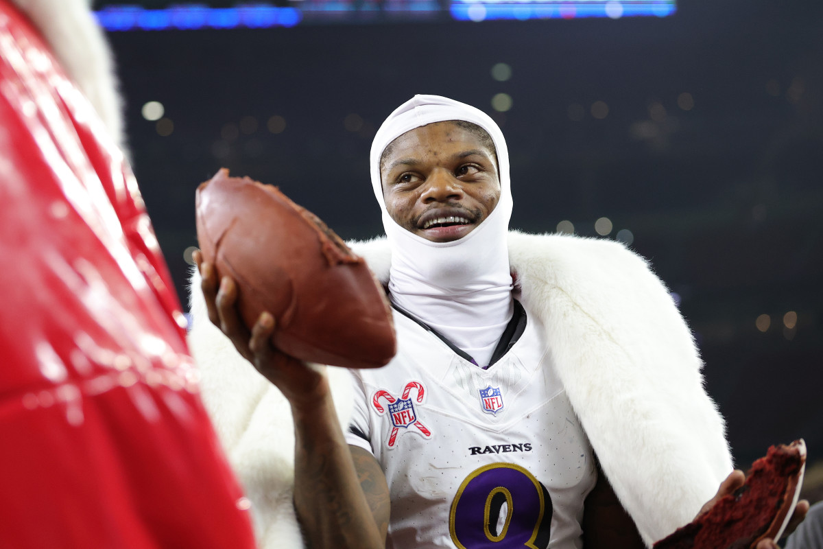 Lamar Jackson holding a cake.