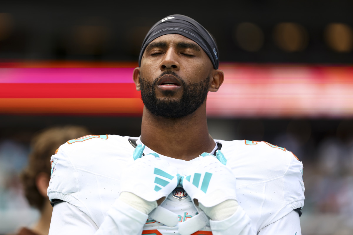 MIAMI GARDENS, FL - NOVEMBER 19: Justin Bethel #20 of the Miami Dolphins stands on the sidelines during the national anthem prior to an NFL football game against the Las Vegas Raiders at Hard Rock Stadium on November 19, 2023 in Miami Gardens, Florida. (Photo by Kevin Sabitus/Getty Images)