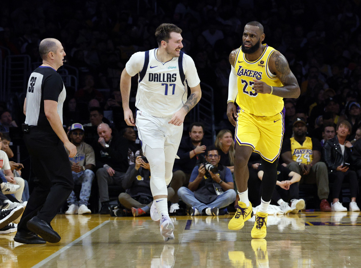 LOS ANGELES, CALIFORNIA - NOVEMBER 22: Luka Doncic #77 of the Dallas Mavericks reacts after scoring a basket against LeBron James #23 of the Los Angeles Lakers during the second half at Crypto.com Arena on November 22, 2023 in Los Angeles, California. NOTE TO USER: User expressly acknowledges and agrees that, by downloading and or using this photograph, User is consenting to the terms and conditions of the Getty Images License Agreement. (Photo by Kevork Djansezian/Getty Images)