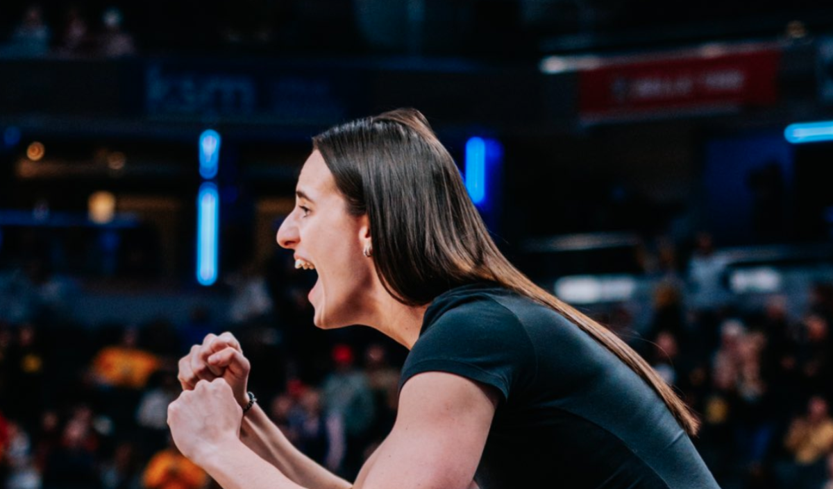 Caitlin Clark flexing at Iowa game.