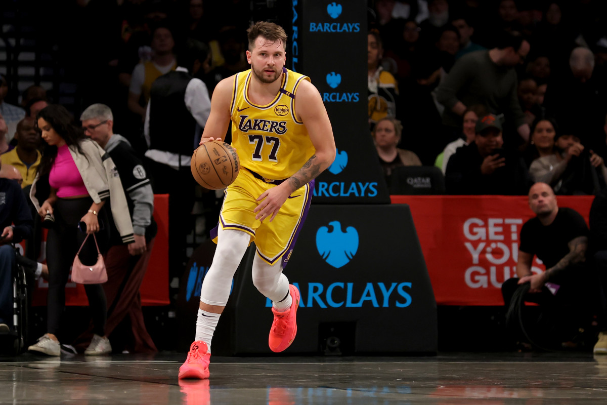 Los Angeles Lakers guard Luka Doncic (77) brings the ball up court against the Brooklyn Nets.