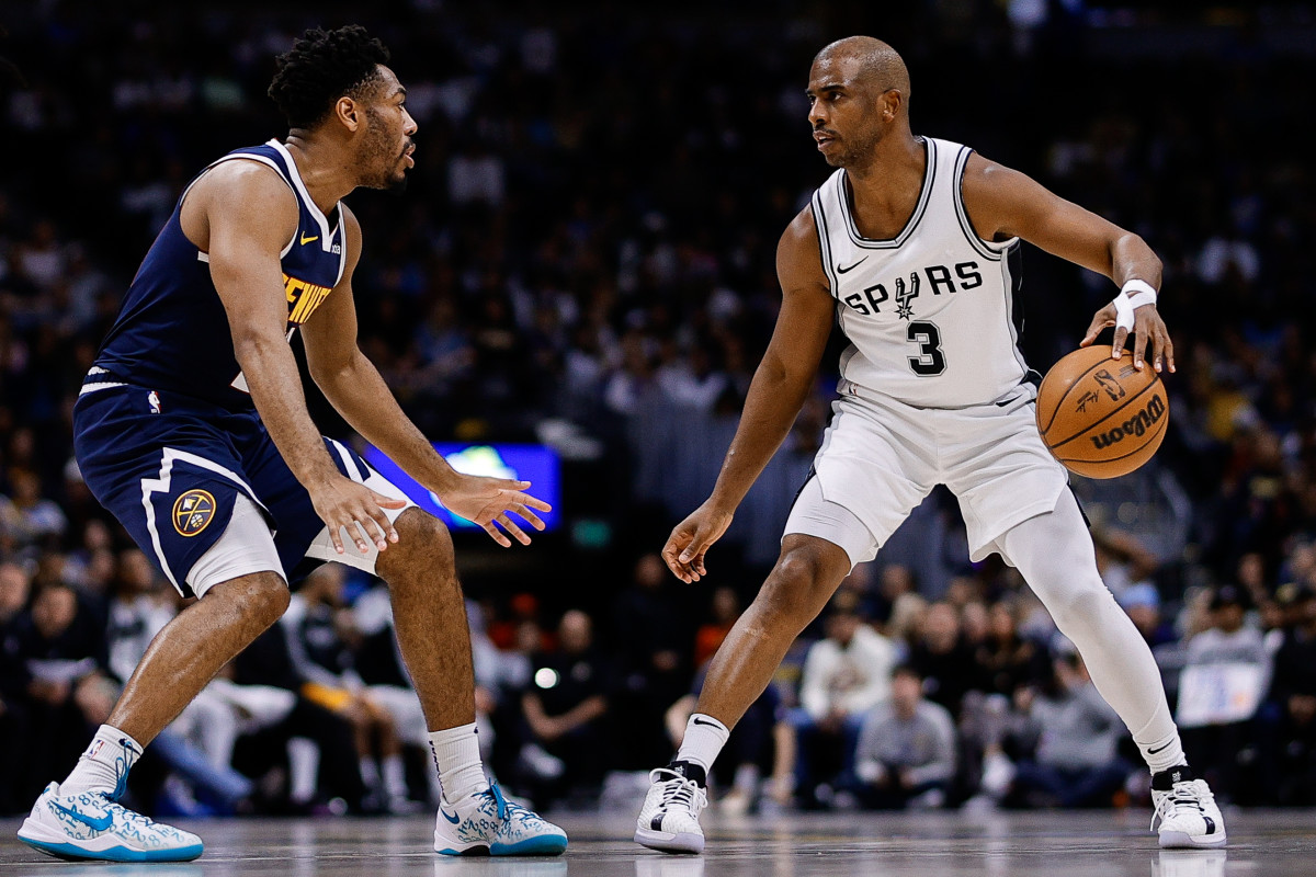 San Antonio Spurs guard Chris Paul (3) controls the ball as Denver Nuggets guard Jalen Pickett (24) guards in the second quarter in the second quarter at Ball Arena. 