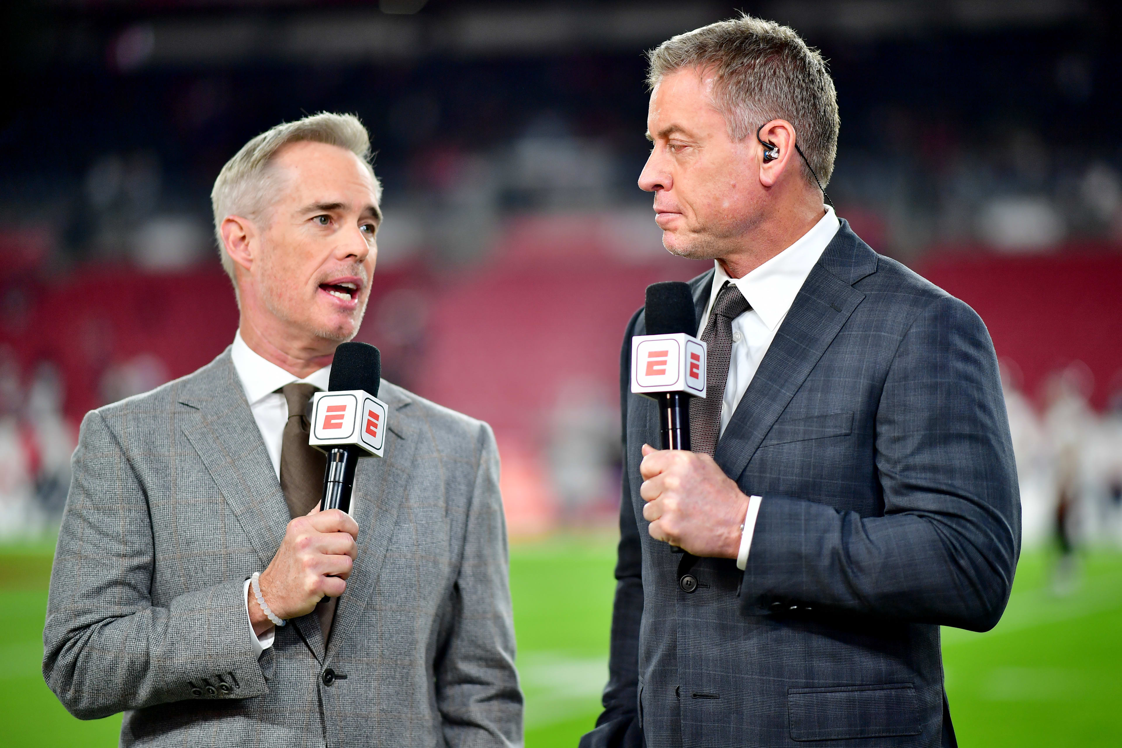 TAMPA, FLORIDA - JANUARY 16: Joe Buck and Troy Aikman look on prior to a game between the Dallas Cowboys and Tampa Bay Buccaneers in the NFC Wild Card playoff game at Raymond James Stadium on January 16, 2023 in Tampa, Florida. (Photo by Julio Aguilar/Getty Images)