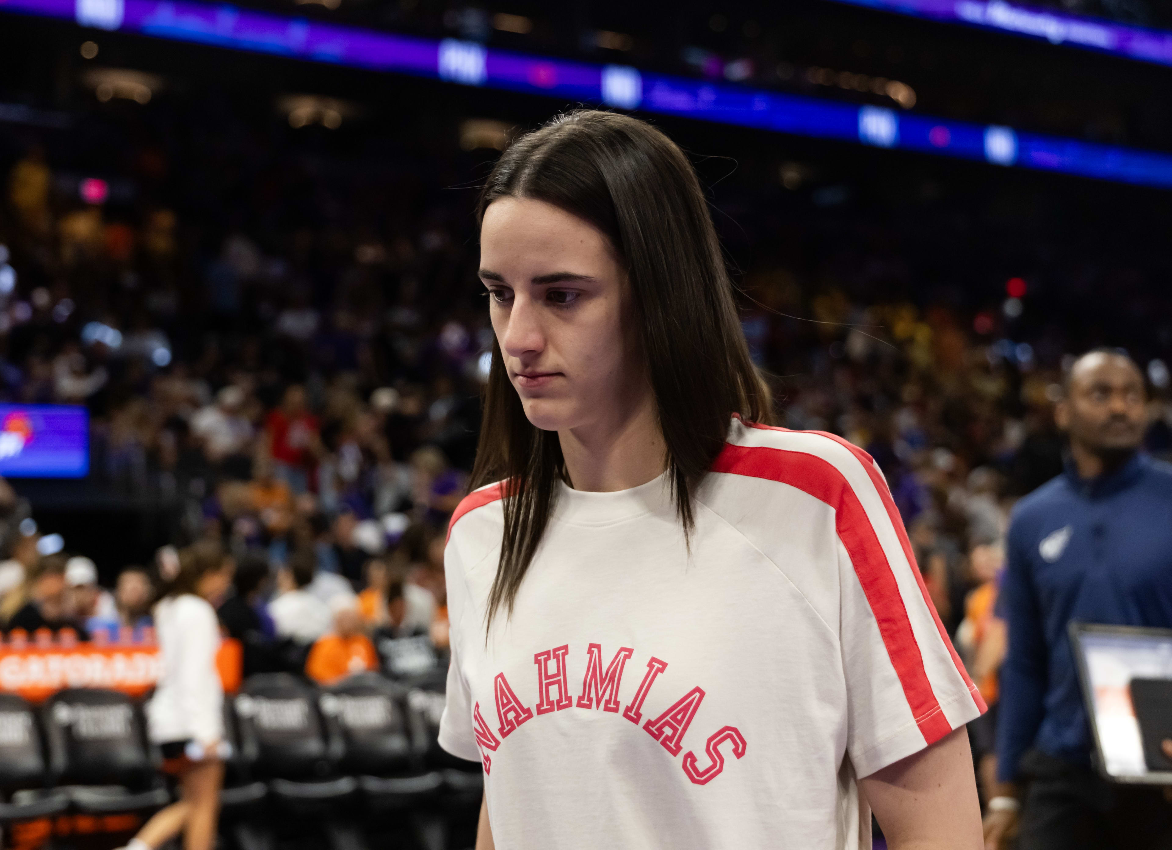 Caitlin Clark walking off court.