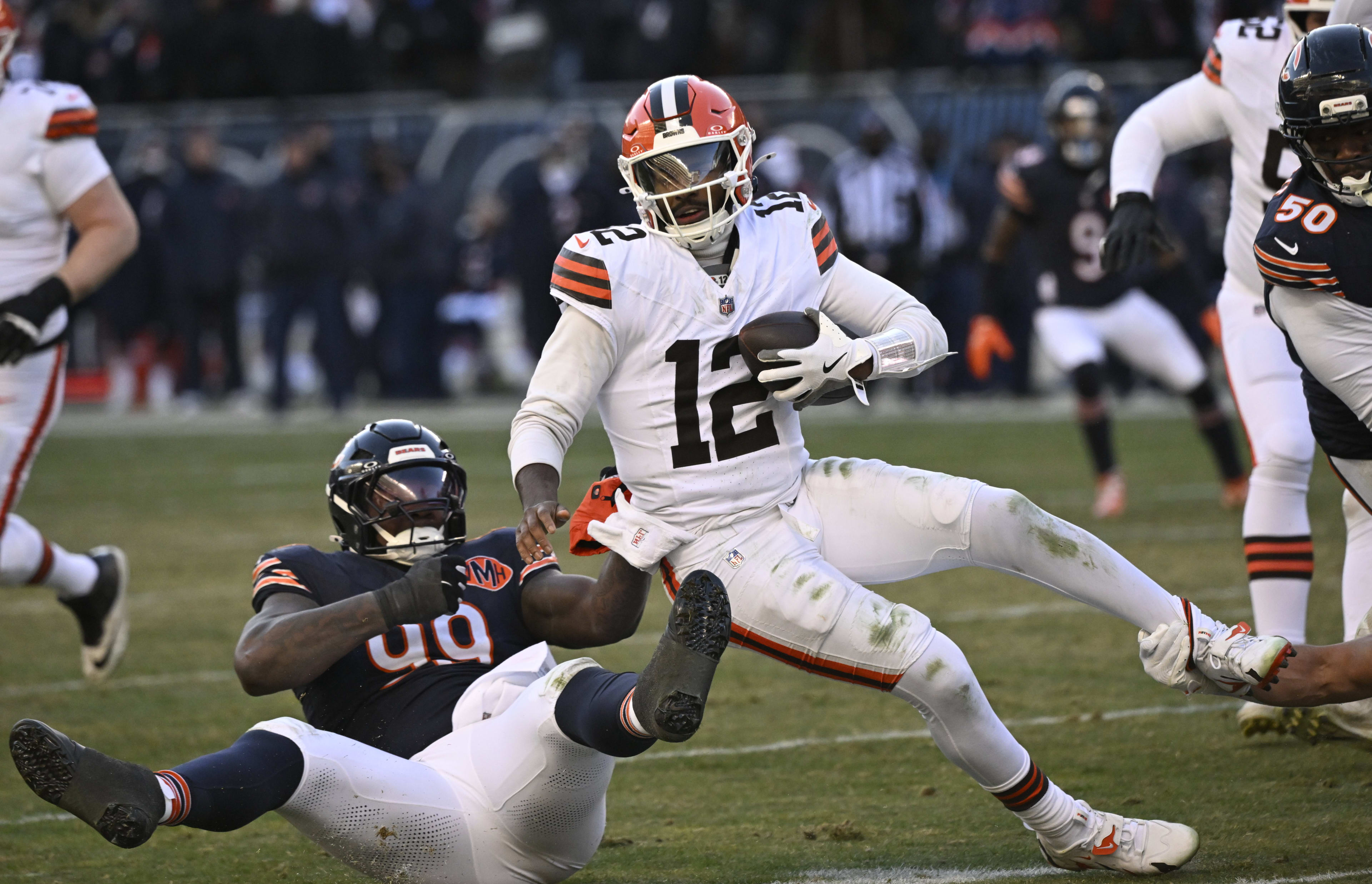 Browns quarterback Shedeur Sanders getting tackled.