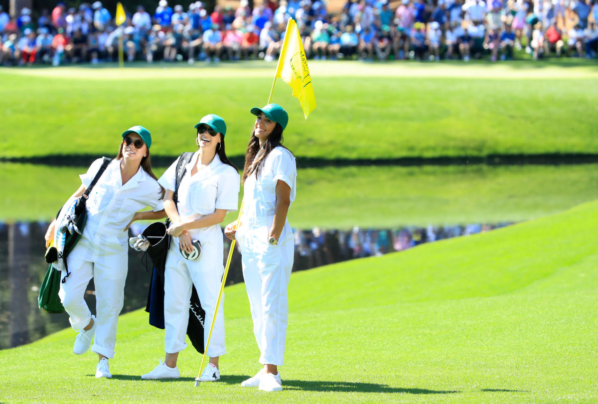 Allison Stokke, Jillian Wisniewski and Annie Verret wearing caddie outfits at The Masters.